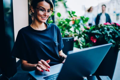 women sitting at her computer working on her rehab marketing plan