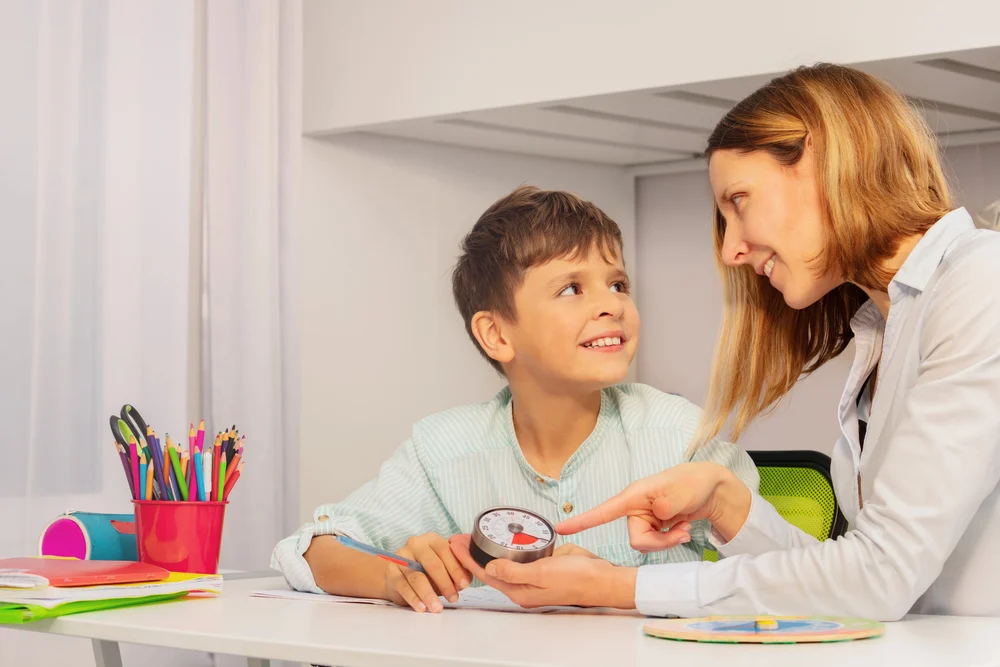 Depositphotos_410470838_S women working with son at an aba therapy treatment center