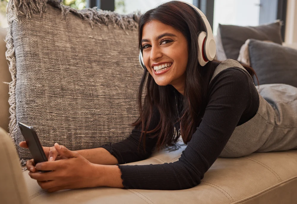 girl streaming a tv show while laying on couch