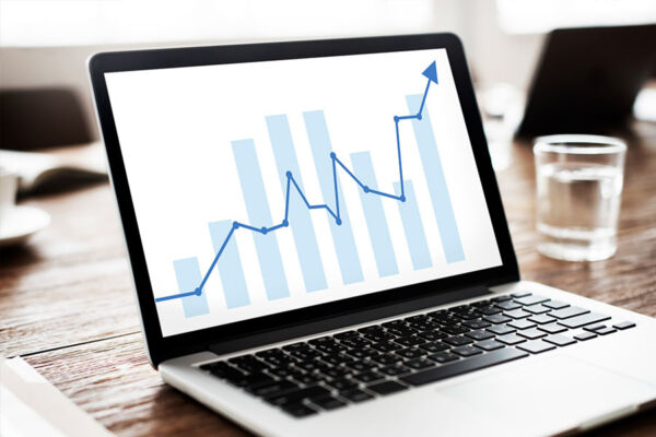 Laptop showing an upward graph concept for increased web traffic
