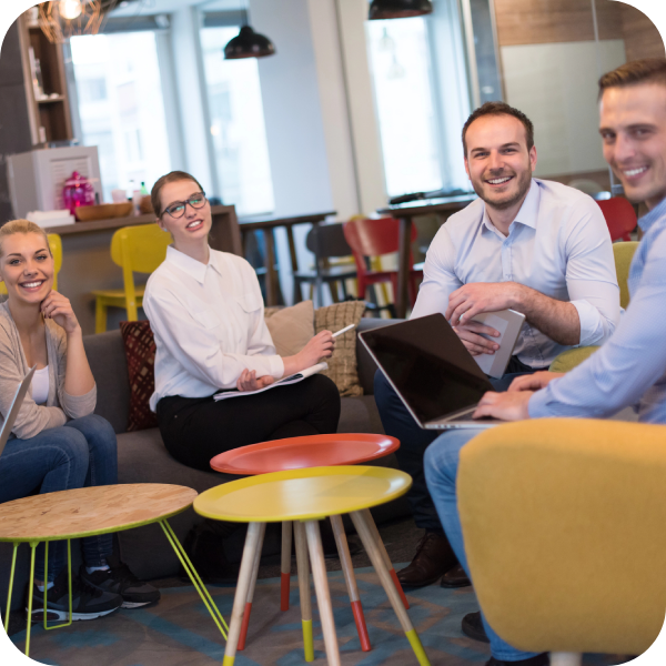team collaborating in a modern office, discussing conversion rate optimization strategies with laptops and notes