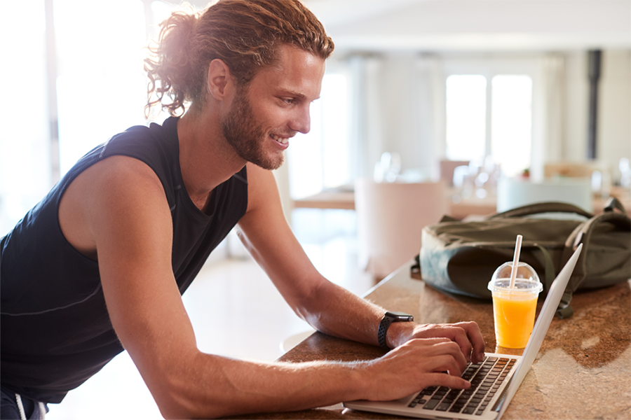 Young man on his laptop checking the newsletter email from an addiction treatment center. Young man on his laptop checking the newsletter email from an addiction treatment center.