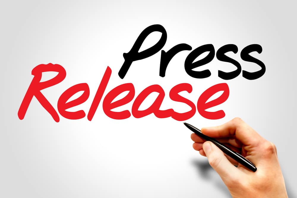 Hand writing Optimized Press Releases, business concept