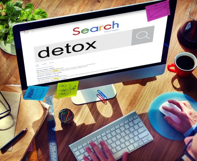 User searching for detox from an addiction treatment center online concept image for rehab keyword research